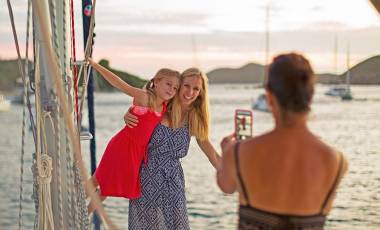 Family taking photos on beach